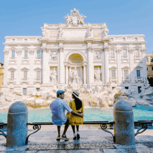 Honeymoon couples making wishes at the trevi fountain at dusk