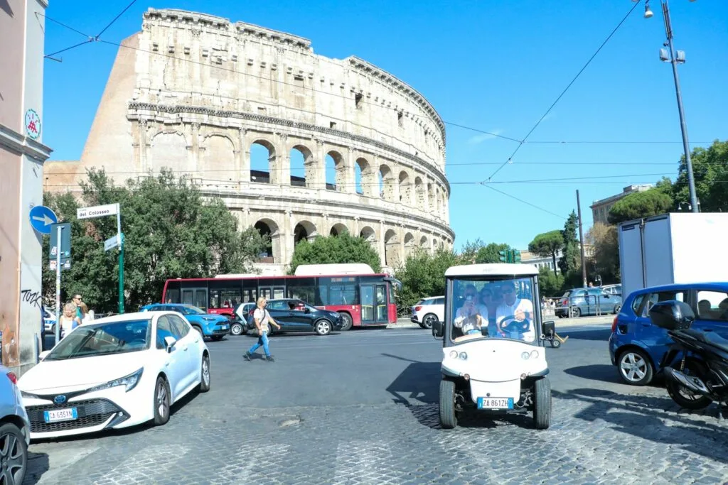 Tourists enjoying golf cart tour near Colosseum